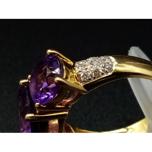 469 - An 18K Yellow Gold and Large Three-Stone Amethyst and Diamond Ring. Three central intense clean amet... 