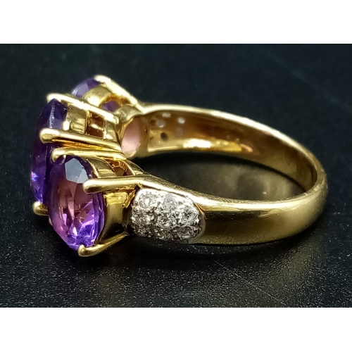 469 - An 18K Yellow Gold and Large Three-Stone Amethyst and Diamond Ring. Three central intense clean amet... 