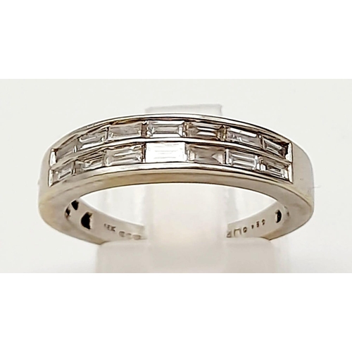 514 - An 18K White Gold Diamond Half Eternity Ring. 14 small baguette cut diamonds. Size N. 4.43g