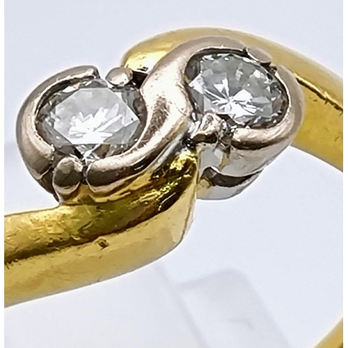 747 - An 18K Yellow Gold Two Diamond Crossover Ring. Size I.
3.12g.