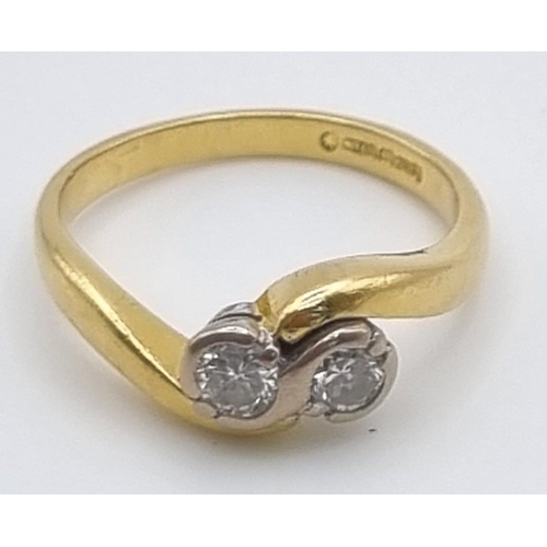 747 - An 18K Yellow Gold Two Diamond Crossover Ring. Size I.
3.12g.