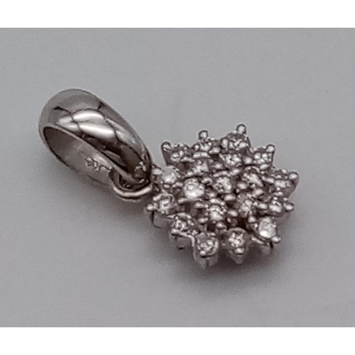 510 - An 18K White Gold Diamond Cluster Pendant. 20 diamonds in a floral pattern. 1.94g.