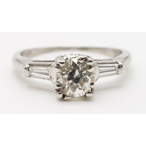 632 - A Platinum Diamond Solitaire Ring. Beautiful round-cut 1ct diamond on platform shoulders. Size K. 3.... 