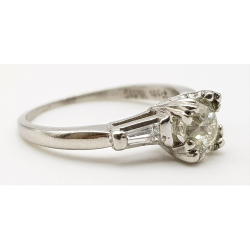 632 - A Platinum Diamond Solitaire Ring. Beautiful round-cut 1ct diamond on platform shoulders. Size K. 3.... 