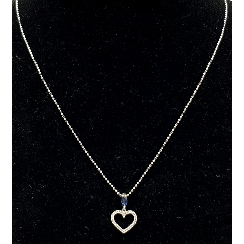 989 - An 18K White Gold Diamond and Sapphire Heart Pendant on an 18K White gold disappearing necklace. 18m... 