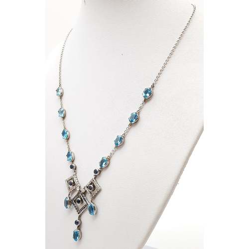 1010 - An Elegant 18K White Gold Necklace - interspersed with clean aquamarine stones and climaxing in a di... 