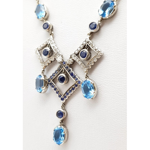 1010 - An Elegant 18K White Gold Necklace - interspersed with clean aquamarine stones and climaxing in a di... 