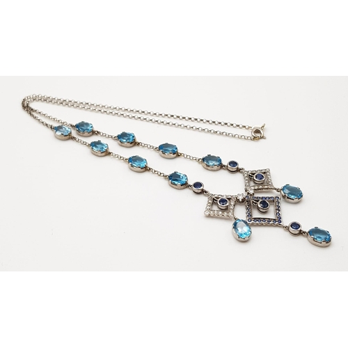 1010 - An Elegant 18K White Gold Necklace - interspersed with clean aquamarine stones and climaxing in a di... 