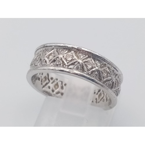 551 - An 18K White Gold Geometric Patterned Diamond Eternity Ring. Size O. 5.6g.