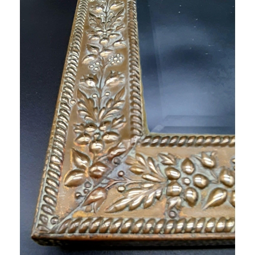 820 - An Early Brass Embossed Mirror in Immaculate Condition. 21 x 38cm.