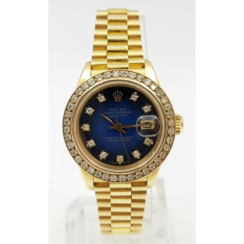 33 - A LADIES 18K GOLD ROLEX OYSTER PERPETUAL DATEJUST WITH SOLID GOLD STRAP ,DIAMOND BEZEL AND NUMERALS ... 