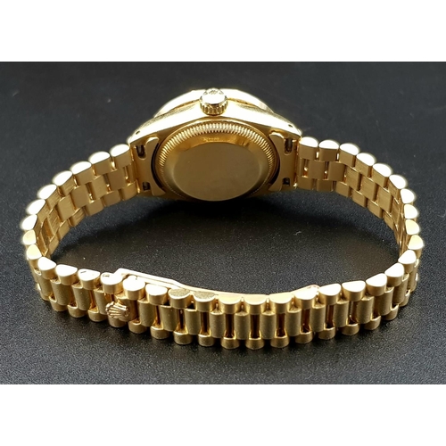 33 - A LADIES 18K GOLD ROLEX OYSTER PERPETUAL DATEJUST WITH SOLID GOLD STRAP ,DIAMOND BEZEL AND NUMERALS ... 
