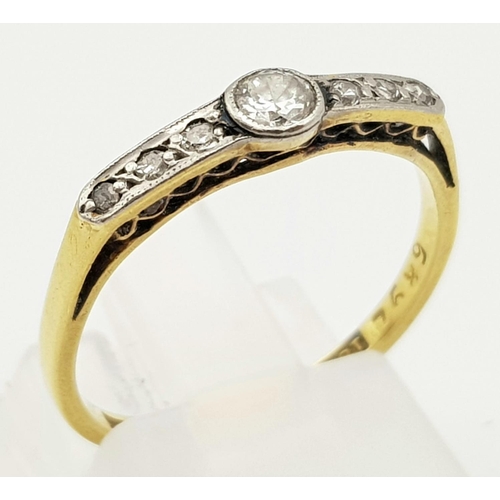 454 - A VINTAGE 18K YELLOW GOLD RING WITH A DIAMOND BRIDGE SET IN PLATINUM ART DECO PERIOD.   2.03gms  siz... 