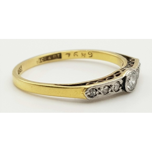 454 - A VINTAGE 18K YELLOW GOLD RING WITH A DIAMOND BRIDGE SET IN PLATINUM ART DECO PERIOD.   2.03gms  siz... 