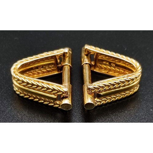 64 - A Vintage Pair of 18K Yellow Gold Kutchinsky Stirrup Cufflinks. Scrolled rope twist borders framing ... 