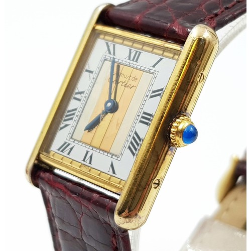 57 - A LADIES CARTIER TANK WATCH IN GOLD PLATED SILVER WITH ORIGINAL CARTIER BURGUNDY STRAP, COMES WITH B... 
