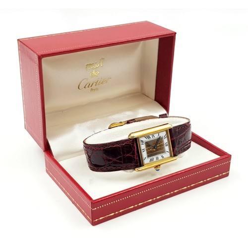 57 - A LADIES CARTIER TANK WATCH IN GOLD PLATED SILVER WITH ORIGINAL CARTIER BURGUNDY STRAP, COMES WITH B... 