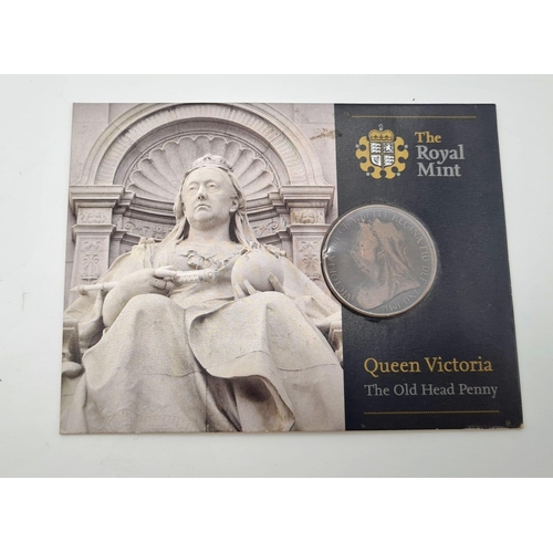 1075 - Four Commemorative Coins. To Include: The Royal Navy £5, Queen Victoria old head penny, We shall kee... 