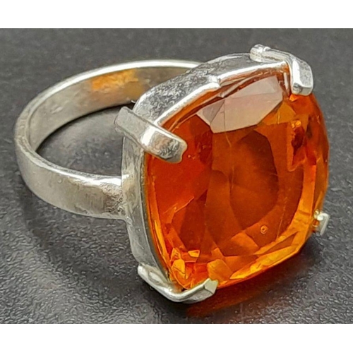 434 - An 25ct Orange Clinohumite Stone Set In 925 Silver Plated Ring. Cushion cut. Size O.