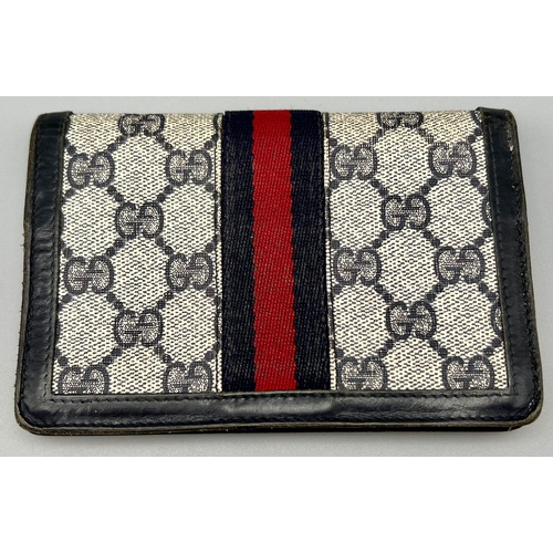 542 - A Used Gucci Monogramed Purse. 15 x 10cm.