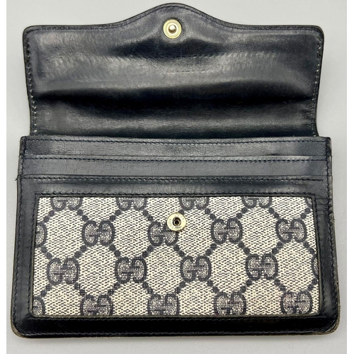 542 - A Used Gucci Monogramed Purse. 15 x 10cm.