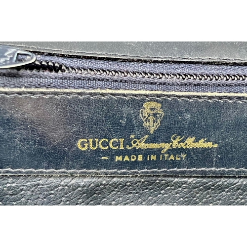 542 - A Used Gucci Monogramed Purse. 15 x 10cm.