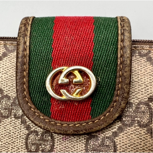 870 - A Small Used Gucci Monogramed Clutch Bag. Needs a clean so A/F. 20 x 11cm.