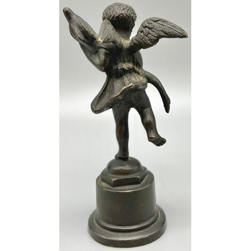 923 - AN ANTIQUE BRONZE STATUE OF AN ANGEL HOLDING A DOLPHIN.  12.2cms tall  283.5gms