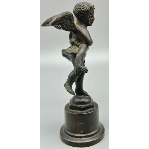 923 - AN ANTIQUE BRONZE STATUE OF AN ANGEL HOLDING A DOLPHIN.  12.2cms tall  283.5gms