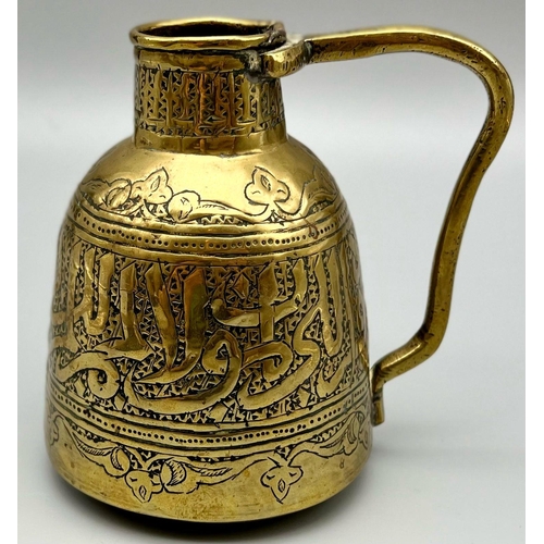 983 - AN ANTIQUE PERSIAN BRASS JUG WITH ISLAMIC CALLIGRAPHY .     12cms tall  230gms