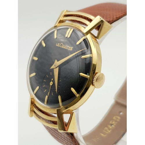 353 - A wonderful, gents, 18 K yellow gold LE COULTRE watch. 30 mm dial, black face with gold hands and ho... 