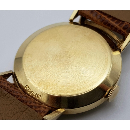 353 - A wonderful, gents, 18 K yellow gold LE COULTRE watch. 30 mm dial, black face with gold hands and ho... 