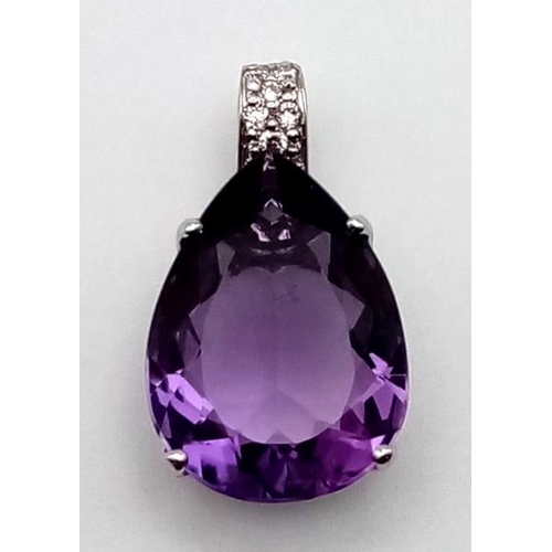 520 - A LARGE AMETHYST TEARDROP STONE SET IN 18K WHITE GOLD AND ENCRUSTED WITH BRIGHT DIAMONDS.  5.9gms  2... 