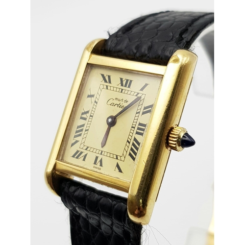 591 - A ladies, 18 K yellow gold electroplated CARTIER TANK watch. 20 mm dial, sapphire on winder, manual ... 