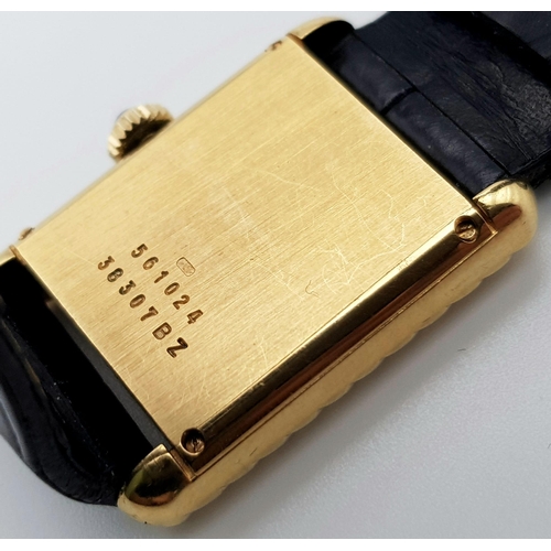 598 - An 18 K yellow gold, ladies, BAUME & MERCIER watch. 20 mm dial, black face with gold hands, sapphire... 