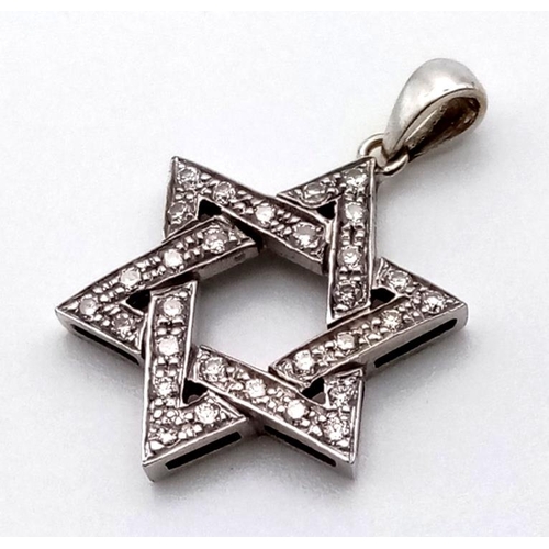 461 - AN 18K WHITE GOLD DIAMOND ENCRUSTED STAR OF DAVID .  1.8gms