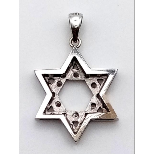 461 - AN 18K WHITE GOLD DIAMOND ENCRUSTED STAR OF DAVID .  1.8gms