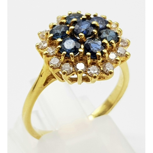 1026 - AN 18K GOLD SAPPHIRE AND DIAMOND CLUSTER RING.  4.6gms  size O/P