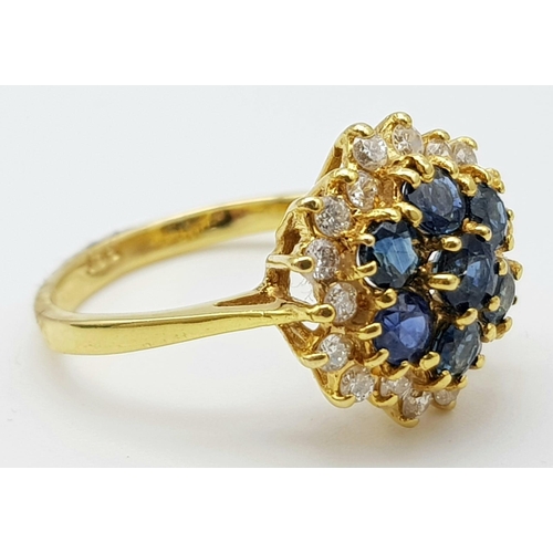 1026 - AN 18K GOLD SAPPHIRE AND DIAMOND CLUSTER RING.  4.6gms  size O/P