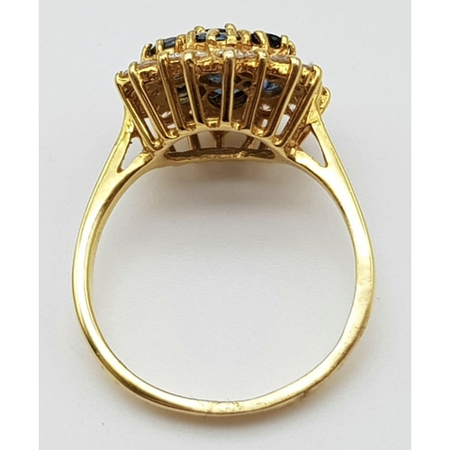 1026 - AN 18K GOLD SAPPHIRE AND DIAMOND CLUSTER RING.  4.6gms  size O/P