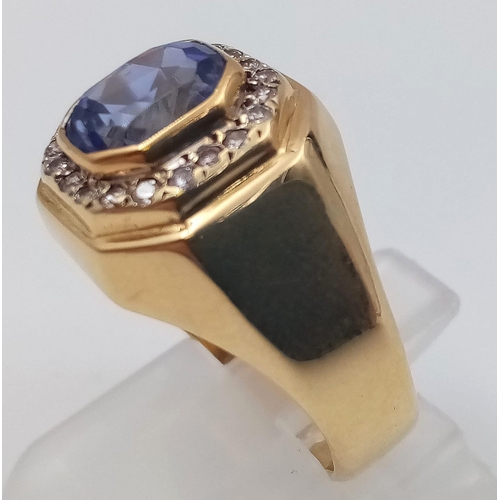 570 - An 18K Yellow Gold Diamond and Tanzanite Ring. Beautiful central blue tanzanite - 2ct, surrounded by... 