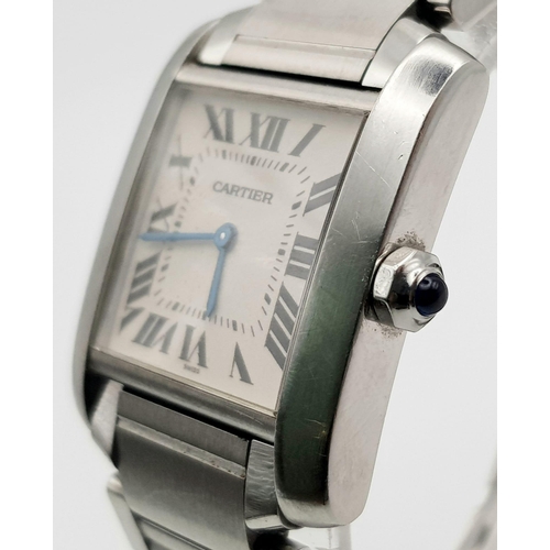 592 - A CARTIER TANK stainless steel ladies watch with blue sapphire on winder. White dial with Roman nume... 