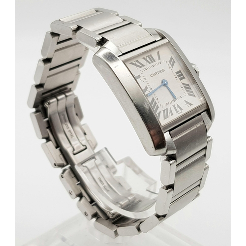 592 - A CARTIER TANK stainless steel ladies watch with blue sapphire on winder. White dial with Roman nume... 