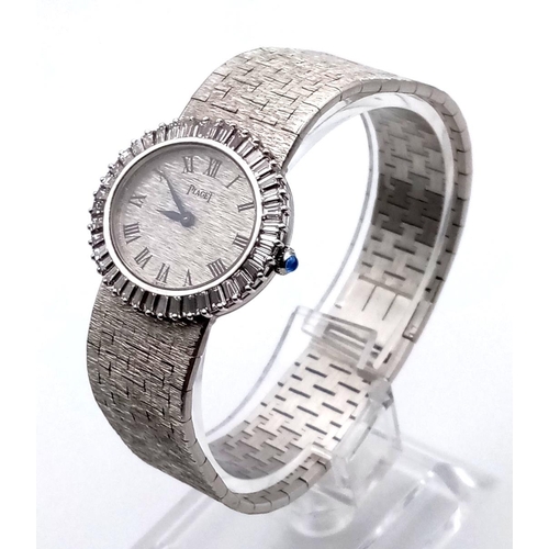 653 - A fashionable, ladies, 18 K white gold PIAGET watch with baguette diamonds on bezel. Oval dial (27 x... 