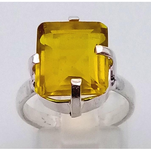 1198 - A 21ct Yellow Kunzite Stone set in a 925 Silver Plated Ring. Emerald cut. Size N