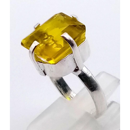 1198 - A 21ct Yellow Kunzite Stone set in a 925 Silver Plated Ring. Emerald cut. Size N