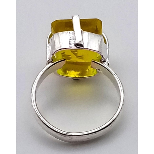 1198 - A 21ct Yellow Kunzite Stone set in a 925 Silver Plated Ring. Emerald cut. Size N