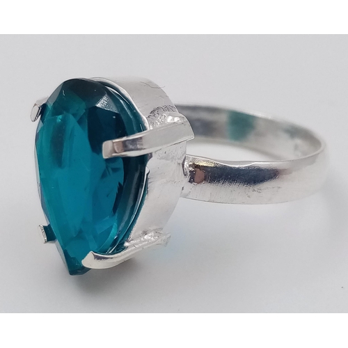 386 - A 20ct Blue Benitoite Stone Set In a 925 Silver Plated Ring. Pear cut. Size P.