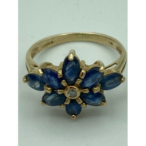 28 - Beautiful 9 carat GOLD, SAPPHIRE and DIAMOND RING, having diamond point to centre with an eight sapp... 