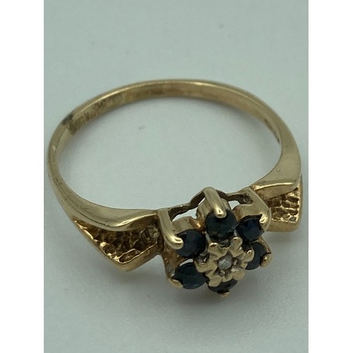 91 - 9 carat GOLD, SAPPHIRE and DIAMOND RING having diamond point to centre with six sapphire surround, d... 